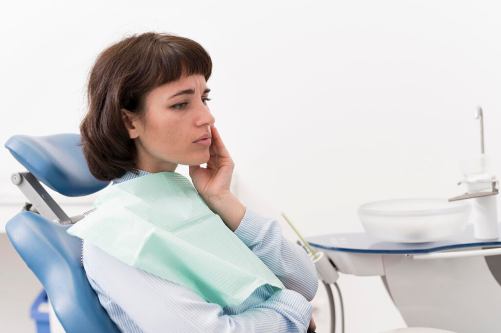 Female patient having a toothache at the dentist's office