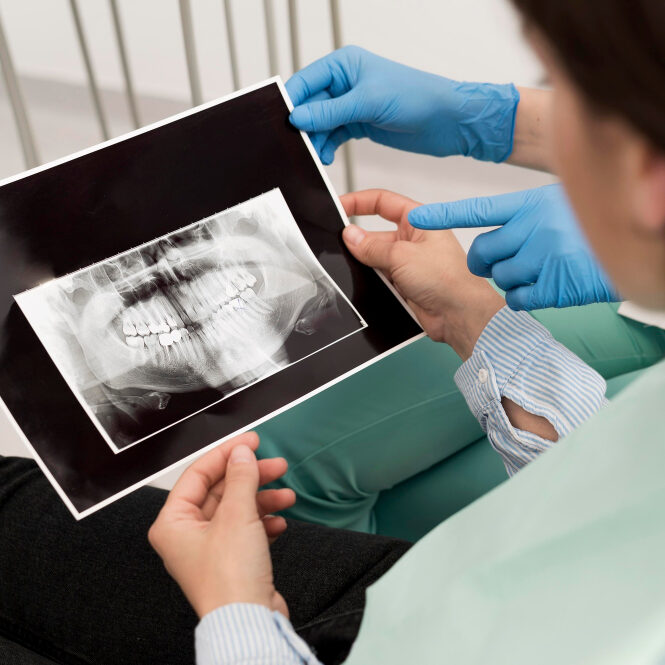 Female patient looking at a radiography of her teeth with the dentist